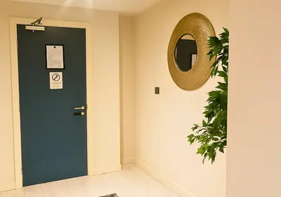 a door with a mirror and a plant next to it at The Vault Liverpool City Centre sleeps 4 in Liverpool