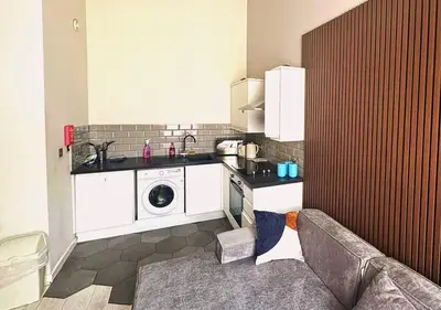 a kitchen with a washing machine and a washer at The Vault Liverpool City Centre sleeps 4 in Liverpool
