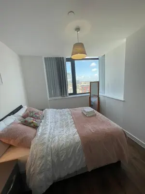 a bedroom with a bed and a large window at 2 Bedroom Apartment with Amazing Views of Liverpool City Centre in Liverpool