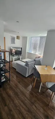 a living room with a couch and a table at 2 Bedroom Apartment with Amazing Views of Liverpool City Centre in Liverpool