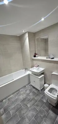 a bathroom with a tub and a toilet and a sink at 2 Bedroom Apartment with Amazing Views of Liverpool City Centre in Liverpool