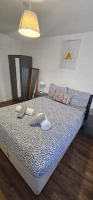 a bedroom with a large bed with towels on it at 2 Bedroom Apartment with Amazing Views of Liverpool City Centre in Liverpool