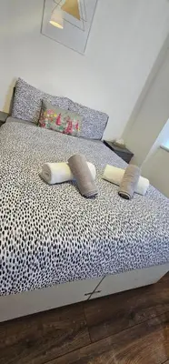 a bed with two pillows on top of it at 2 Bedroom Apartment with Amazing Views of Liverpool City Centre in Liverpool