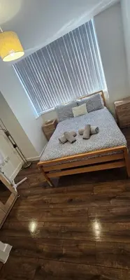 a bedroom with a bed with two slippers on it at 2 Bedroom Apartment with Amazing Views of Liverpool City Centre in Liverpool