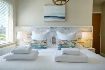 a bedroom with a white bed with two pillows at The Bolt Hole in Silverdale