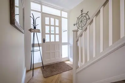 a hallway with a door and a tripod in a room at The Bolt Hole in Silverdale