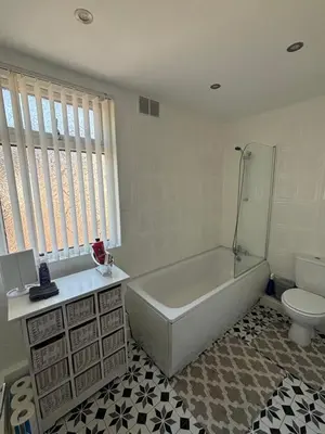 a white bathroom with a tub and a toilet at Affordable room near Anfield stadium - 5 minute walk in Liverpool