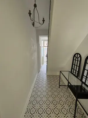 a hallway with a glass table and a chandelier at Affordable room near Anfield stadium - 5 minute walk in Liverpool