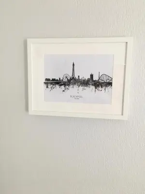 a picture on a wall with a picture of a city at Chadberry House Hotel in Blackpool