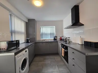 a kitchen with a washer and dryer in it at Room 3 Shared house in Kensington in Liverpool