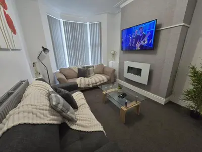 a living room with a couch and a tv at Room 3 Shared house in Kensington in Liverpool