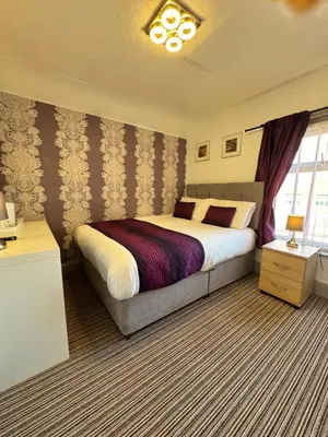 a bedroom with a large bed in a room at On The Beach Hotel in Blackpool