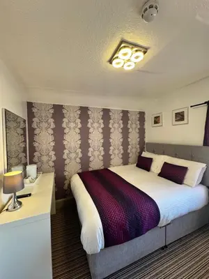a bedroom with a large bed in a room at On The Beach Hotel in Blackpool