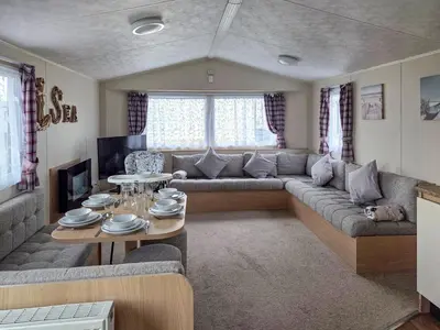 a living room with a couch and a table at Waterlily in Lancaster