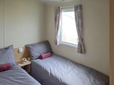 a bedroom with two twin beds and a window at Waterlily in Lancaster