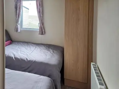 a small bedroom with a bed and a window at Waterlily in Lancaster