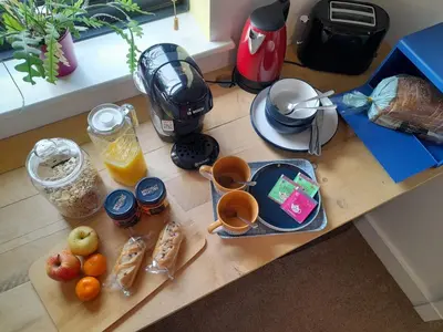 a table with food and drinks on a counter at Double room, living space and bathroom, in a family home, near Ulverston in Pennington