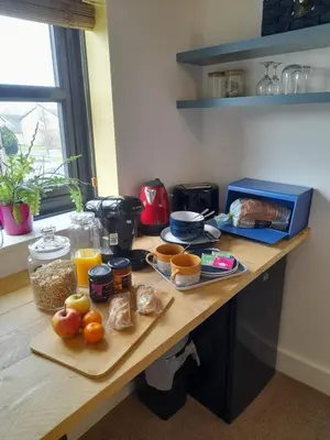 a table with some food on top of it at Double room, living space and bathroom, in a family home, near Ulverston in Pennington