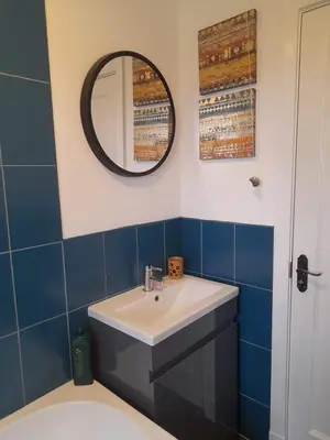 a bathroom with a sink and a mirror at Double room, living space and bathroom, in a family home, near Ulverston in Pennington
