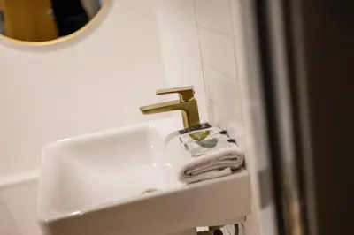 a sink with a faucet in a bathroom at Baltic Apt II - City Centre with Parking, Sleeps 6 in Liverpool