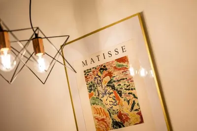 a picture hanging on a wall next to a light fixture at Baltic Apt II - City Centre with Parking, Sleeps 6 in Liverpool