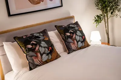 a bedroom with a bed with two pillows on it at Baltic Apt II - City Centre with Parking, Sleeps 6 in Liverpool