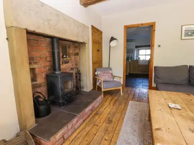 a living room with a brick fireplace and a couch at Sunnybrook Cottage in Lancaster