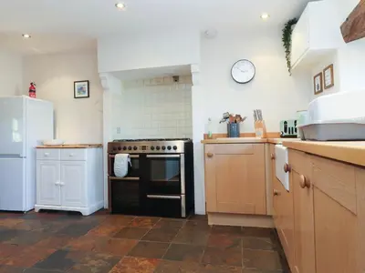 a kitchen with a stove and a refrigerator at Sunnybrook Cottage in Lancaster