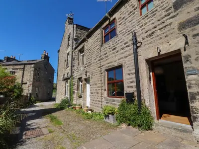 an old stone building with a door on a street at Sunnybrook Cottage in Lancaster
