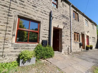a brick building with a window and a door at Sunnybrook Cottage in Lancaster