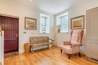 a living room with a bench and a chair at 3 Bed in West Bradford oc-g32102 in West Bradford
