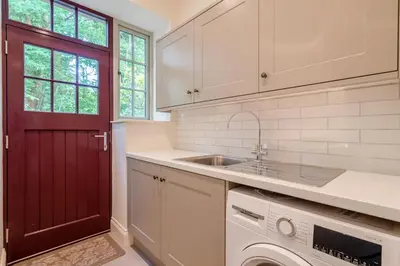 a kitchen with a sink and a red door at 3 Bed in West Bradford oc-g32102 in West Bradford