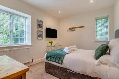 a bedroom with a bed and a tv on the wall at 3 Bed in West Bradford oc-g32102 in West Bradford
