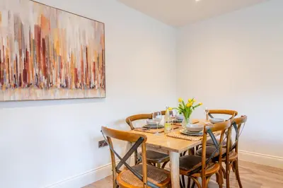 a dining room table with chairs and a painting on the wall at 2 Bed in West Bradford oc-c32101 in West Bradford