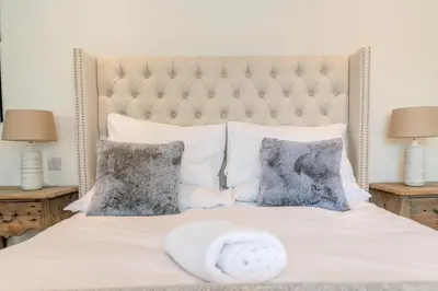 a bed with a white blanket and pillows at 2 Bed in West Bradford oc-c32101 in West Bradford