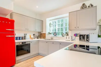 a kitchen with white cabinets and a red refrigerator at 2 Bed in West Bradford oc-c32101 in West Bradford