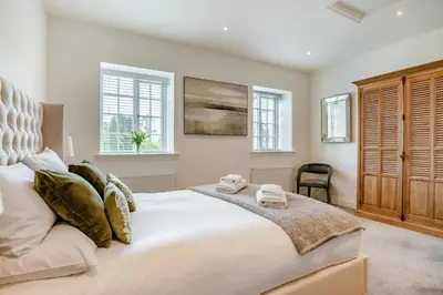 a bedroom with a large white bed and windows at 1 Bed in West Bradford oc-g32100 in West Bradford