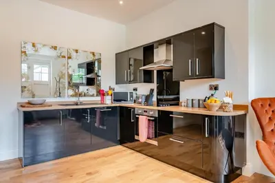 a kitchen with black cabinets and a wooden counter top at 1 Bed in West Bradford oc-g32100 in West Bradford