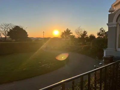a view of the sunset from a balcony of a house at Ismay Lounge Apartment- Titanic Interest in Liverpool