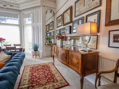 a living room with a couch and a table at Ismay Lounge Apartment- Titanic Interest in Liverpool