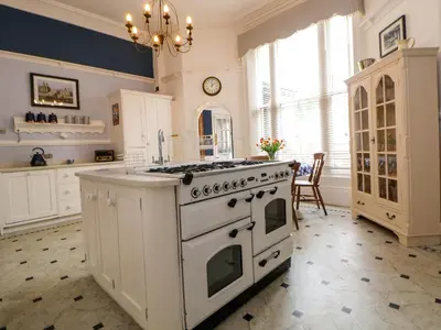 a kitchen with a white stove and a counter at Ismay Lounge Apartment- Titanic Interest in Liverpool