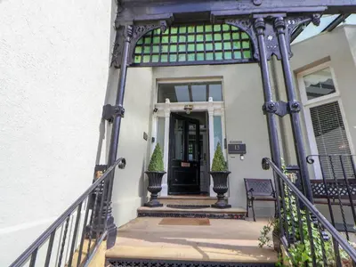 a front porch of a house with a black door at Ismay Lounge Apartment- Titanic Interest in Liverpool