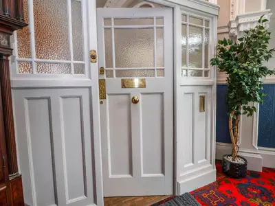 a white door in a room with a potted plant at Ismay Lounge Apartment- Titanic Interest in Liverpool