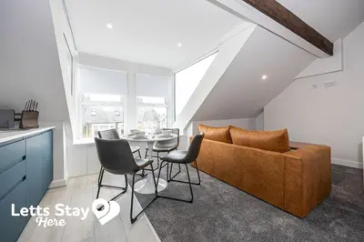 a living room with a couch and a table at Morecambe Bay Stays in Morecambe