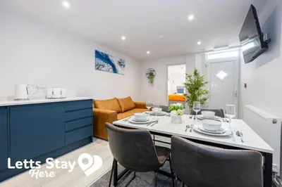 a kitchen and living room with a table and chairs at Morecambe Bay Stays in Morecambe