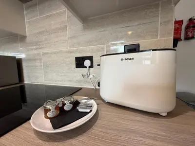a coffee machine sitting on top of a wooden counter at Anfield Courtyard Retreat in Liverpool