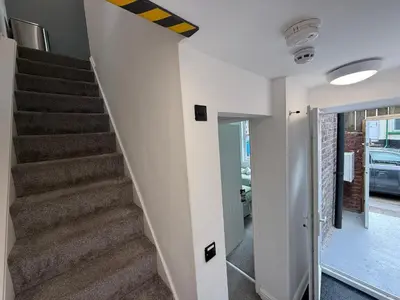 a staircase in a home with white walls at Anfield Courtyard Retreat in Liverpool