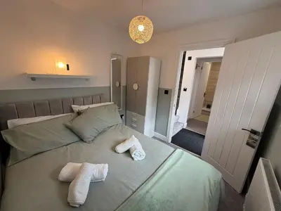 a bedroom with two towels sitting on a bed at Anfield Courtyard Retreat in Liverpool
