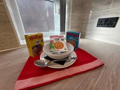 a bowl of oatmeal and cereal on a red towel at Anfield Courtyard Retreat in Liverpool