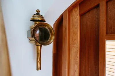 a mirror is attached to a wooden door at The Carriage House at the Talbot in Lytham St Annes